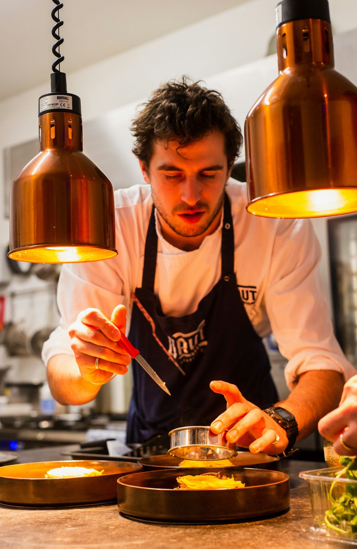 Chef preparing a fresh smashed burger
